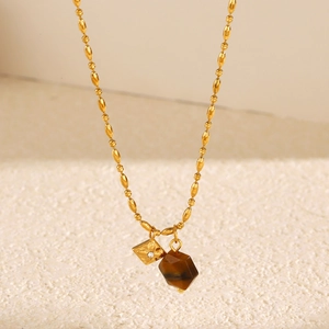Golden beaded necklace with tiger eye stone and diamond-shaped zircon charms