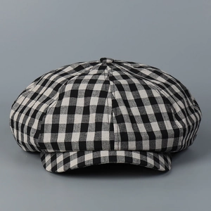 Close-up of black and white checkered linen newsboy cap with eight-panel stitching