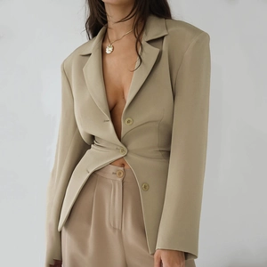 Detail of khaki two-piece set with a fitted blazer and high-waisted skirt suit