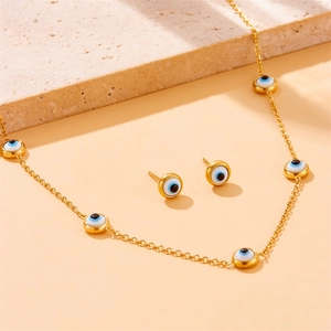 Golden Evil Eye jewelry set featuring a multi-pendant necklace and matching stud earrings