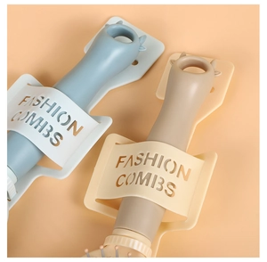 Detail of blue and khaki combs in fashion wall-mounted holders on orange background
