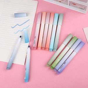 Gradient aesthetic high-capacity highlighters set on pink desk with notebook