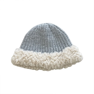 Winter plush knit bucket hat in grey and beige tones with soft faux fur trim