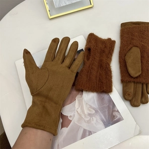Close-up of brown suede gloves with plush faux fur trim and delicate flower embroidery