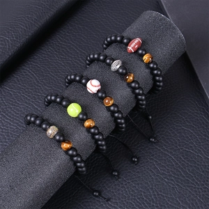 Detail of adjustable matte bead bracelets with tiger eye stones and sports ball charms