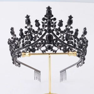 Birthday Queen set featuring a black metal crown with black gemstones on a display stand