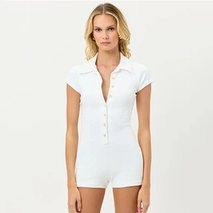 Close-up of white short-sleeved romper with polo collar and button-front closure