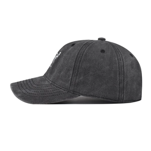 Detail of side white embroidery on washed dark grey cotton baseball cap with eyelets