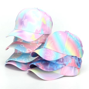 Close-up of colorful tie-dye baseball caps with butterfly and heart patterns for kids