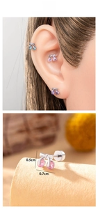 Detailed macro view showing the 0.7x0.5cm cherry earrings with bow and cubic zirconia