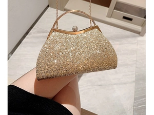 Close-up of golden sequin evening clutch bag with metal handle and chain link strap