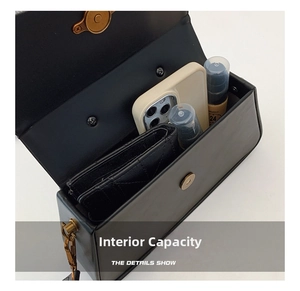 Top view of compact black leather crossbody bag showing interior storage for phone and wallet