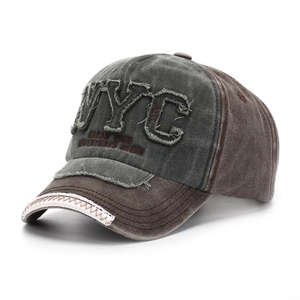Detail of vintage NYC patch embroidery and washed cotton texture on a baseball cap