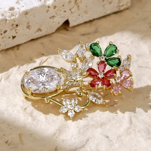 Macro detail of golden flower brooch with colorful cubic zirconia and crystal stones