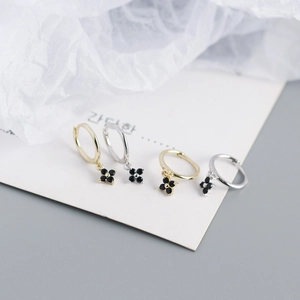 Detail of S925 silver flower hoop earrings with black zircon in gold and silver finish