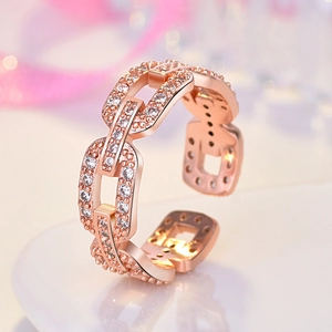 Macro detail of rose gold double-layer chain ring with sparkling pave crystals