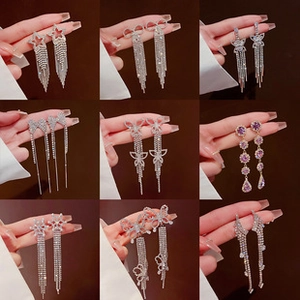 Detailed grid showing long silver tassel earrings with crystal stars and butterfly designs