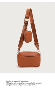 Detailed view of brown quilted leather crossbody bag with matching coin purse attachment