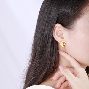 Modern gold hollow circular geometric rhinestone earrings worn by a model in a side profile