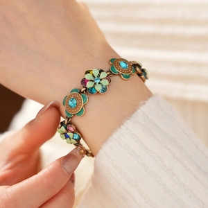 Close-up of vintage flower bracelet with colorful crystals and enamel on model's wrist
