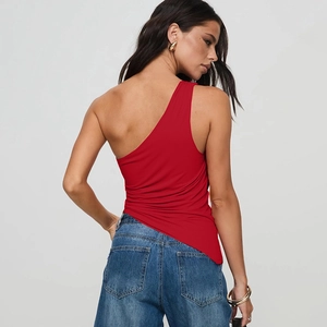 Slim fit red one-shoulder sleeveless top paired with blue jeans in a stylish summer look