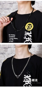 Close-up of heavy titanium steel chain with skull link details and round clasp