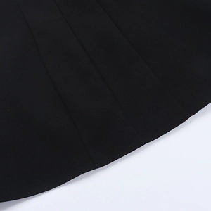 Macro detail of the high-quality black woven fabric and neat stitching on dress hem