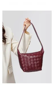 Detail view of burgundy woven leather shoulder bag showing the premium checkerboard texture