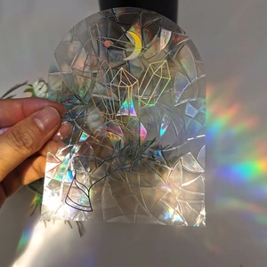 Macro view of arched holographic suncatcher window sticker with crystal and moon design