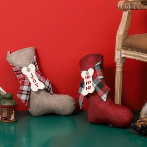 Red and tan linen Christmas stockings with plaid bows and bone tags for fireplace decor