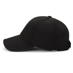 Profile view of a black quick-dry baseball cap with breathable perforated fabric