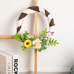 Easter rattan wreath with white bunny, yellow sunflower, and green leaves on wood