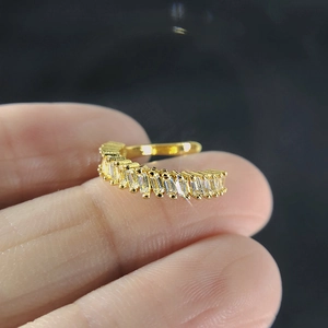 Macro shot of gold-plated ear cuff with pavé-set rectangular cubic zirconia crystals