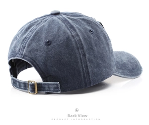 Detail view of washed denim baseball cap with adjustable bronze metal buckle