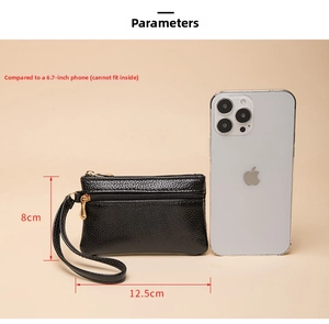 Mini black leather coin purse 12.5x8cm shown next to a 6.7 inch phone for size scale