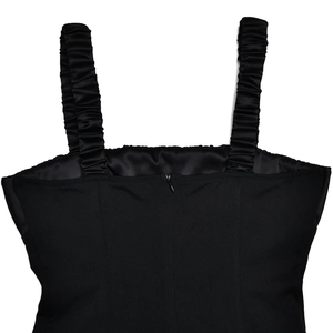 Detail view of the square neck black dress featuring ruffled straps and back zipper closure
