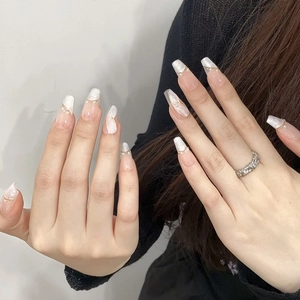 French marble press-on nails with pink pearls and gold accents for elegant manicure