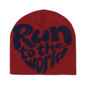 Macro detail of wine red knitted beanie featuring navy blue Run to the world text