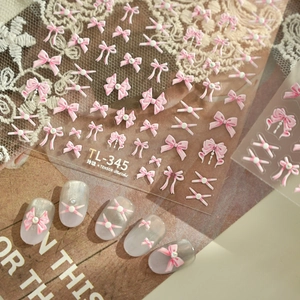 3D pink ribbon bow nail stickers with pearl accents on grey nails and TL-345 sheet