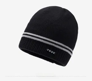 Detailed view of black knitted beanie with grey stripes and soft fleece lining for winter