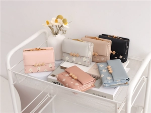 Close-up of floral print PU leather mini wallets in pink, grey, beige, blue and black