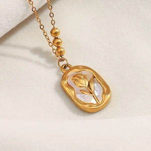 Detailed close-up of 18K gold plated sun flower pendant necklace with mother of pearl inlay
