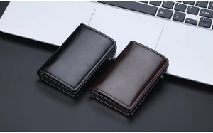 Business setup showing black and dark brown leather RFID wallets near a laptop