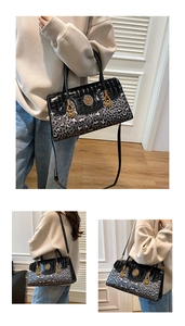 Detail of elegant leopard print and faux crocodile leather handbag with gold accents