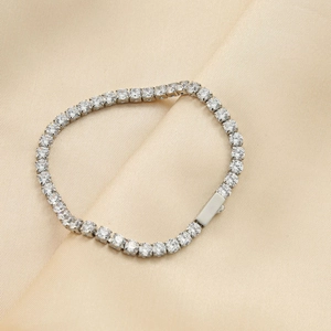 Luxury stainless steel tennis bracelet with 5A cubic zirconia on champagne silk fabric