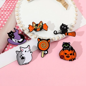 Detailed view of Halloween enamel pins with black cat, pumpkin, and witch hat motifs