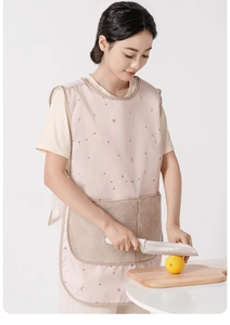 Detail of pink kitchen apron with star pattern featuring a mesh back and large front pocket