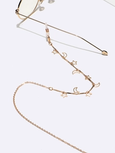 Details der goldenen Brillenkette mit hohlen Stern- und Mondsichelelementen und Silikonenden