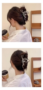 Silver bow hair claw clip with pearl detail shown on a woman wearing a white shirt