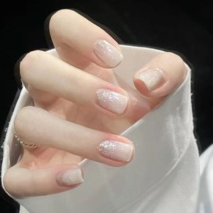 Press-on nails with nude to white gradient and silver glitter tips on square shape